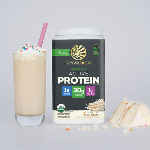 Container of Sunwarrior organic active protein powder beside a vanilla milkshake with sprinkles and cake slices