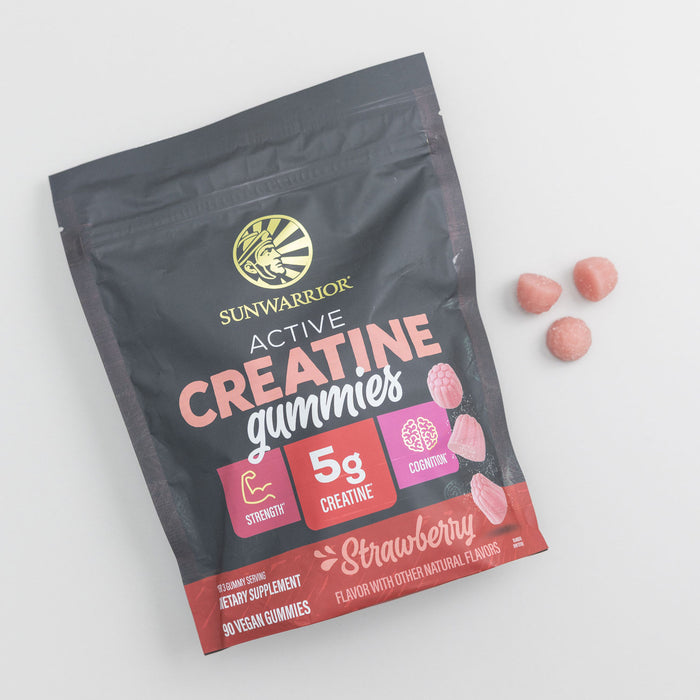 Sunwarrior Active Creatine gummies pouch with strawberry flavored pink gummies beside it on white background